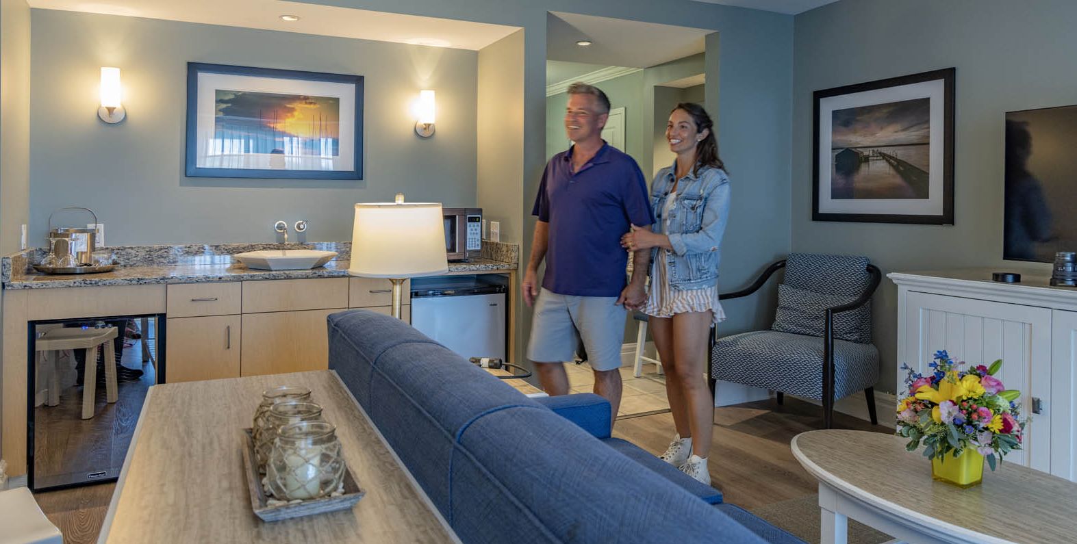 A couple walking into a Lake View Suite at the Watkins Glen Harbor Hotel