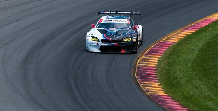 A BMW race car circles a turn at Watkins Glen International