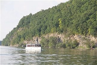 Boat on water in front of mountain